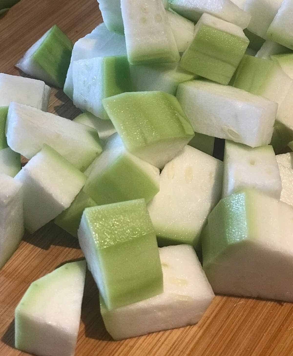 chopped pieces of bottle gourd on a wooden board