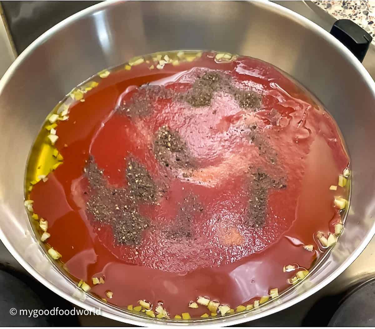 tomato sauce with spices in a pan