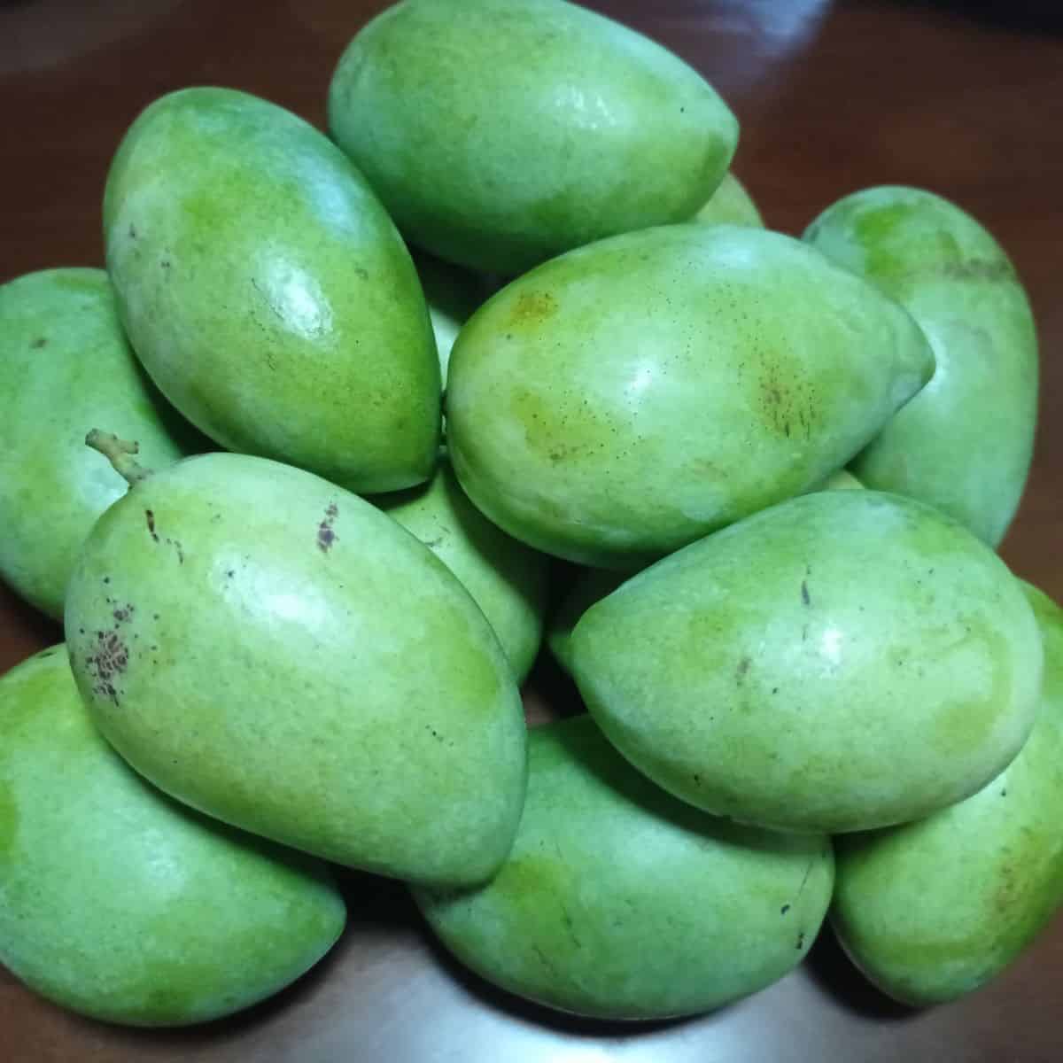 Unripe mangoes placed one on top of the other. These are used as souring agents in cooking. 