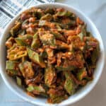 Bhindi masala dish served in a white bowl with a patterned napkin on the side,