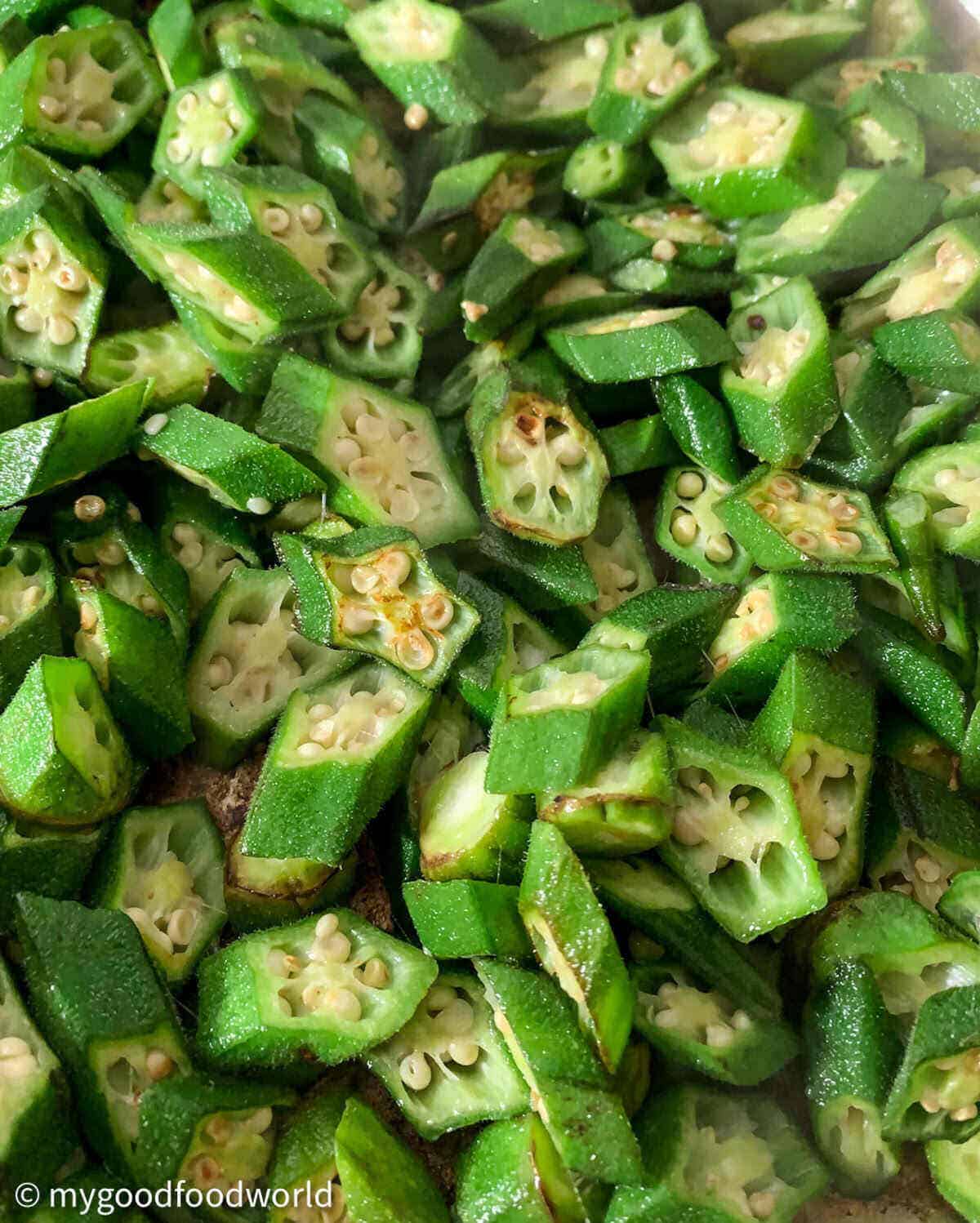 Sliced okra pieces frting in oil till they get a slight brown coloring on them.