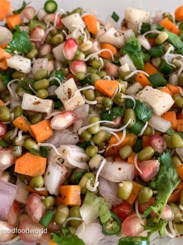 A close-up photo of sprouted mung beans salad with vegetables and pomegranate.
