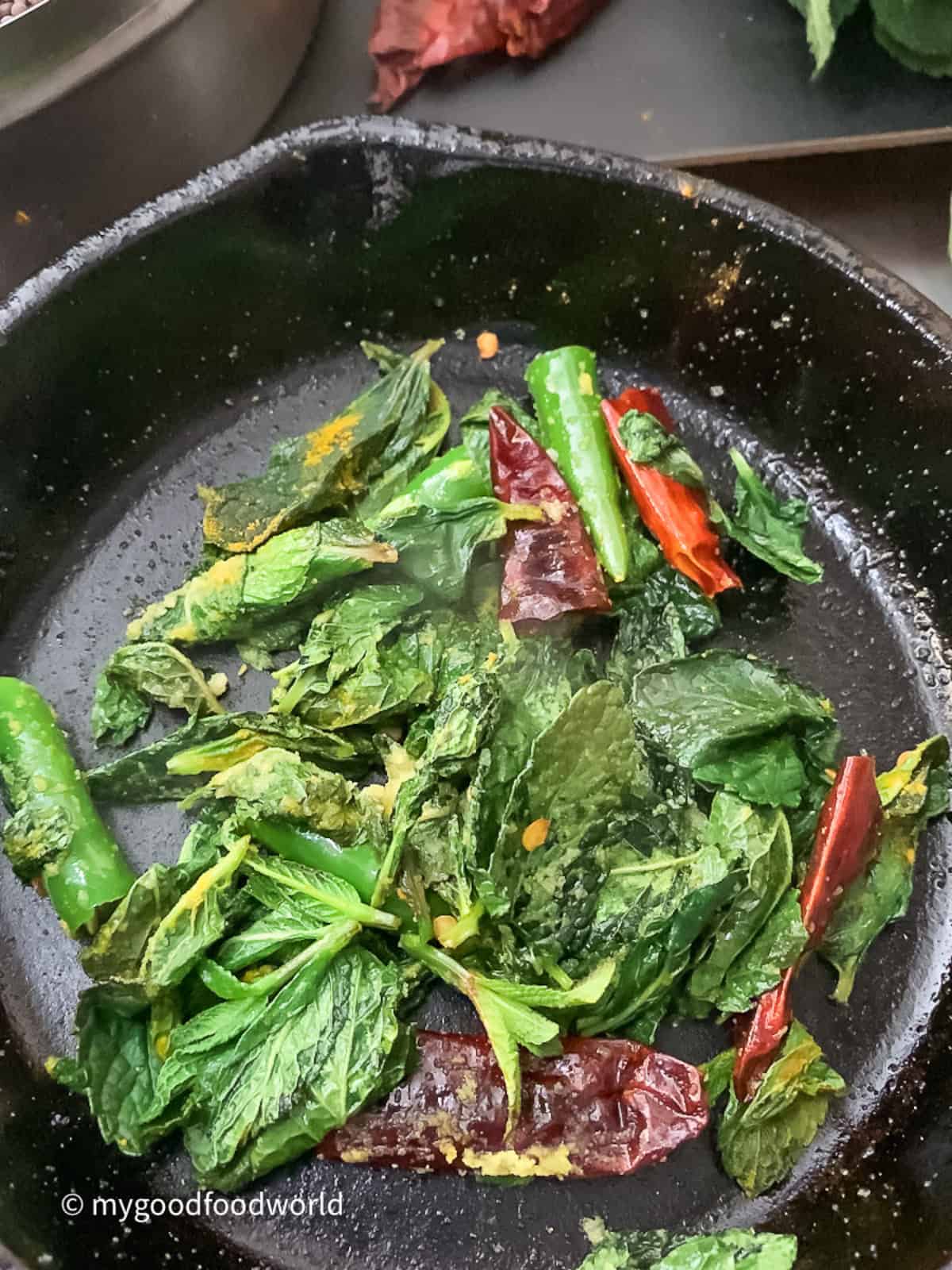 Mint leaves, chilies, and spices fried in oil for chutney.