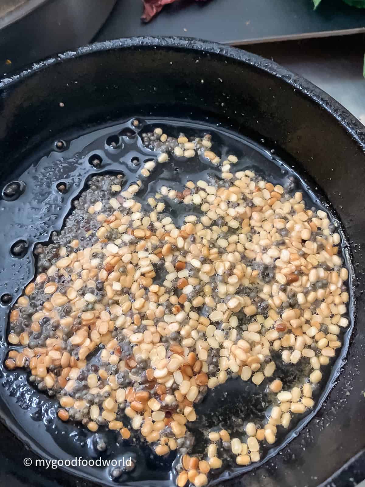 White lentils and mustard seeds fried in oil for coconut chutney.