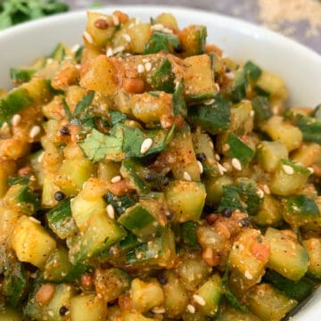 Andhra-style spicy cucumber chutney with sesame seeds garnish placed in a white bowl.