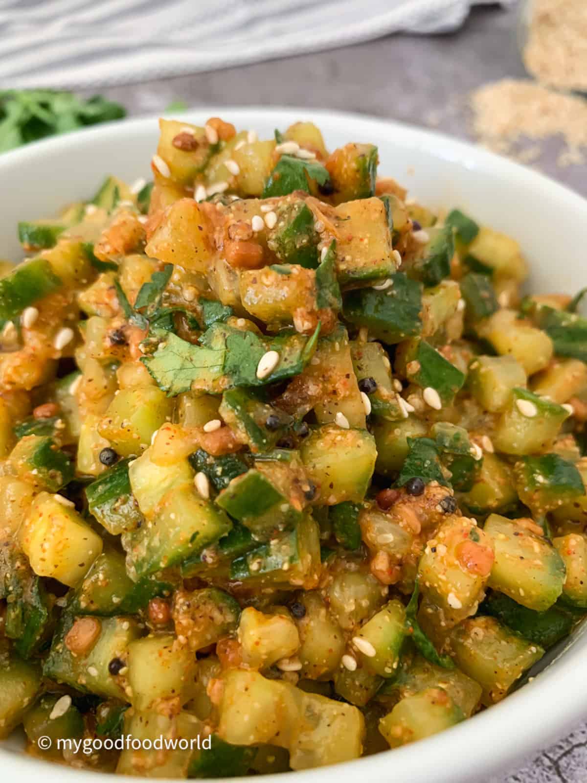 Andhra-style spicy dosakaya chutney with sesame seeds garnish placed in a white bowl.