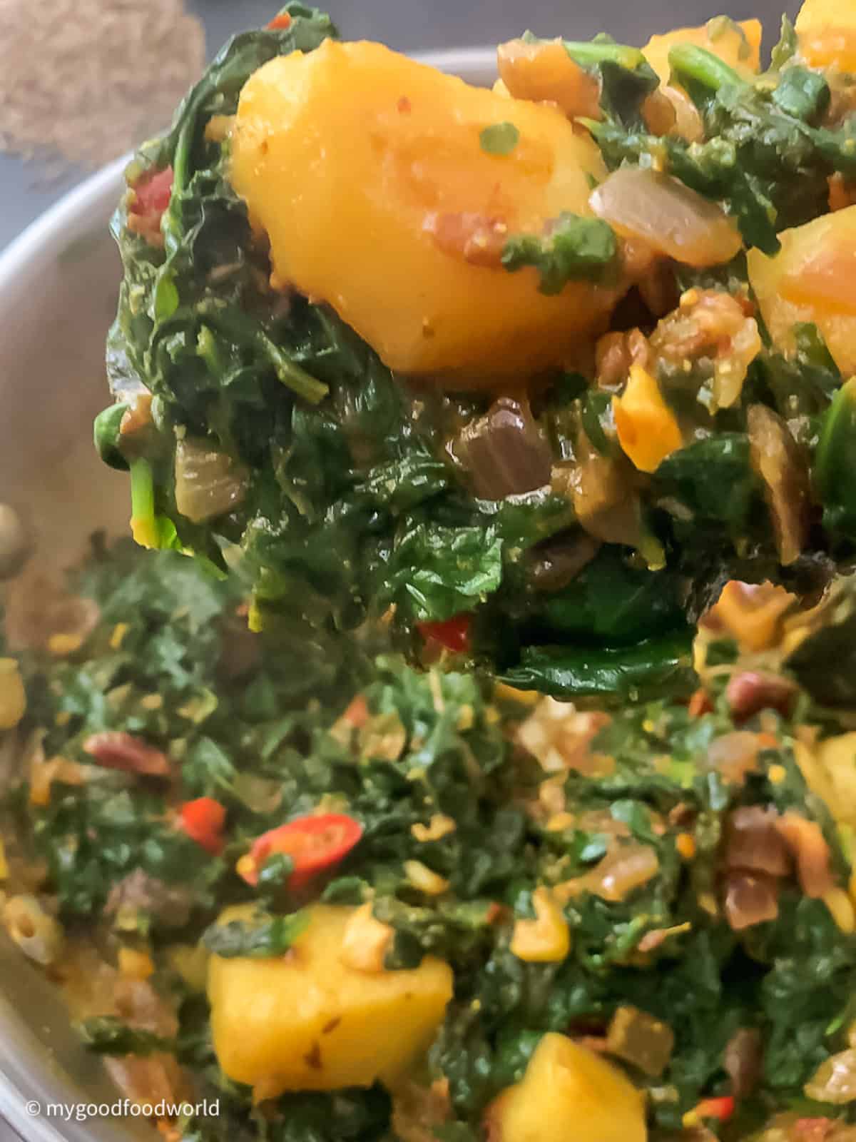 Aloo palak curry cooked to perfection with the potatoes soft cooked and the spinach coating the potatoes.