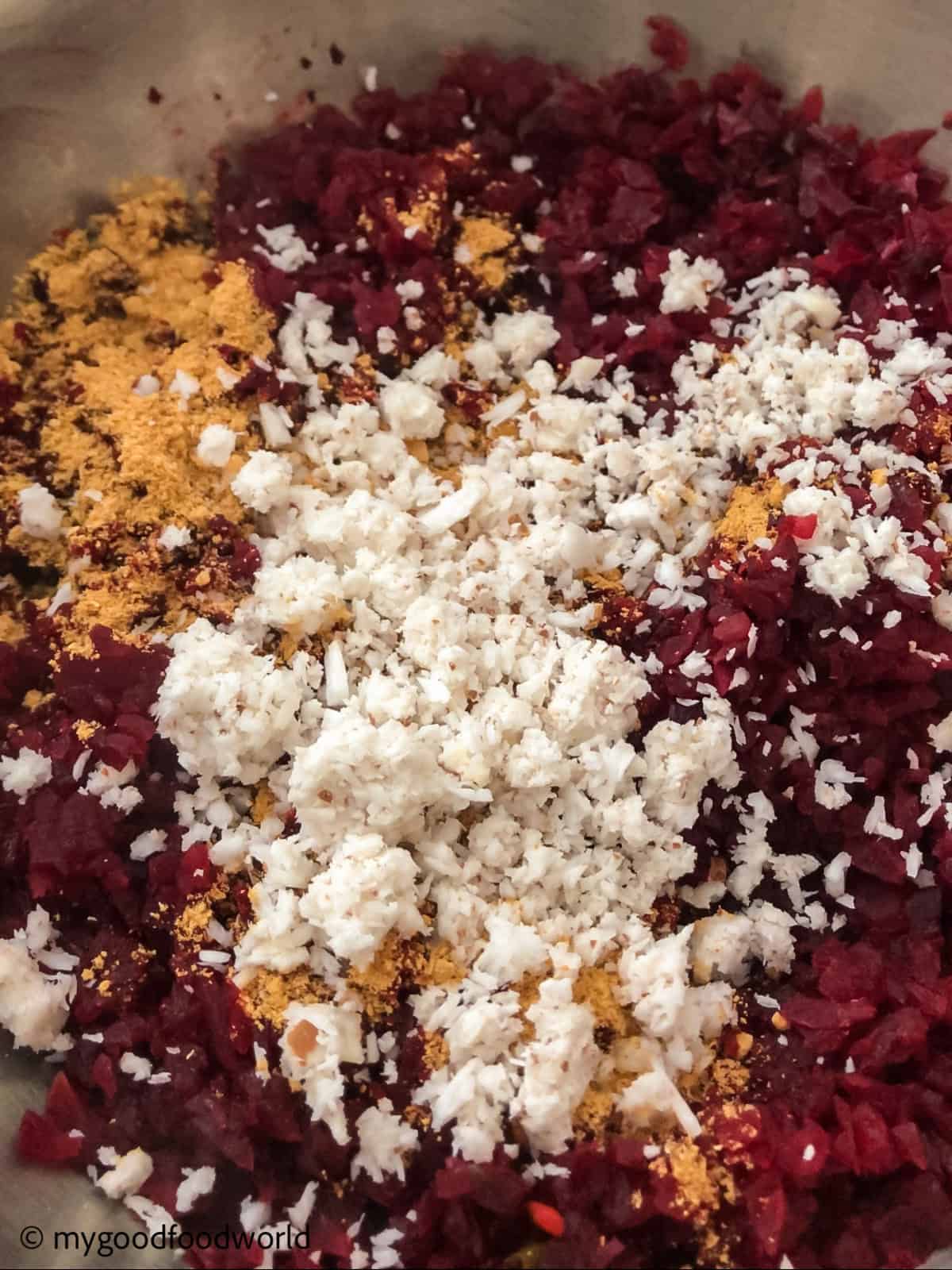 Freshly grated coconut is being added to beetroot thoran dish.