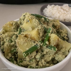 A delicious bowl of alu posto with beans, a Bengali curry with potatoes, green beans, and poppy seeds.
