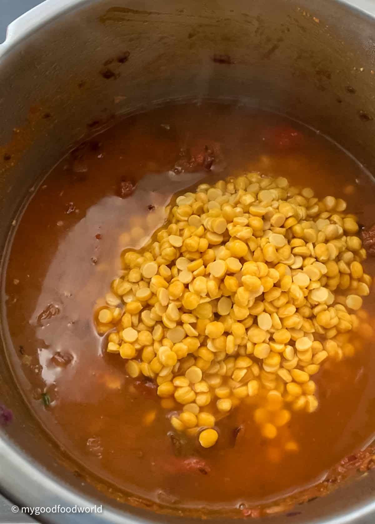 Chana dal is placed in a pot with some water for making a dish,