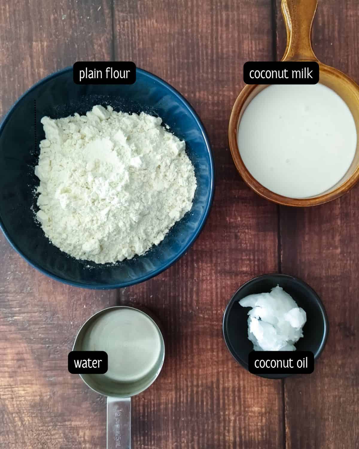 To make crepes, ingredients such as plain flour and coconut milk are placed on a wooden tabletop.