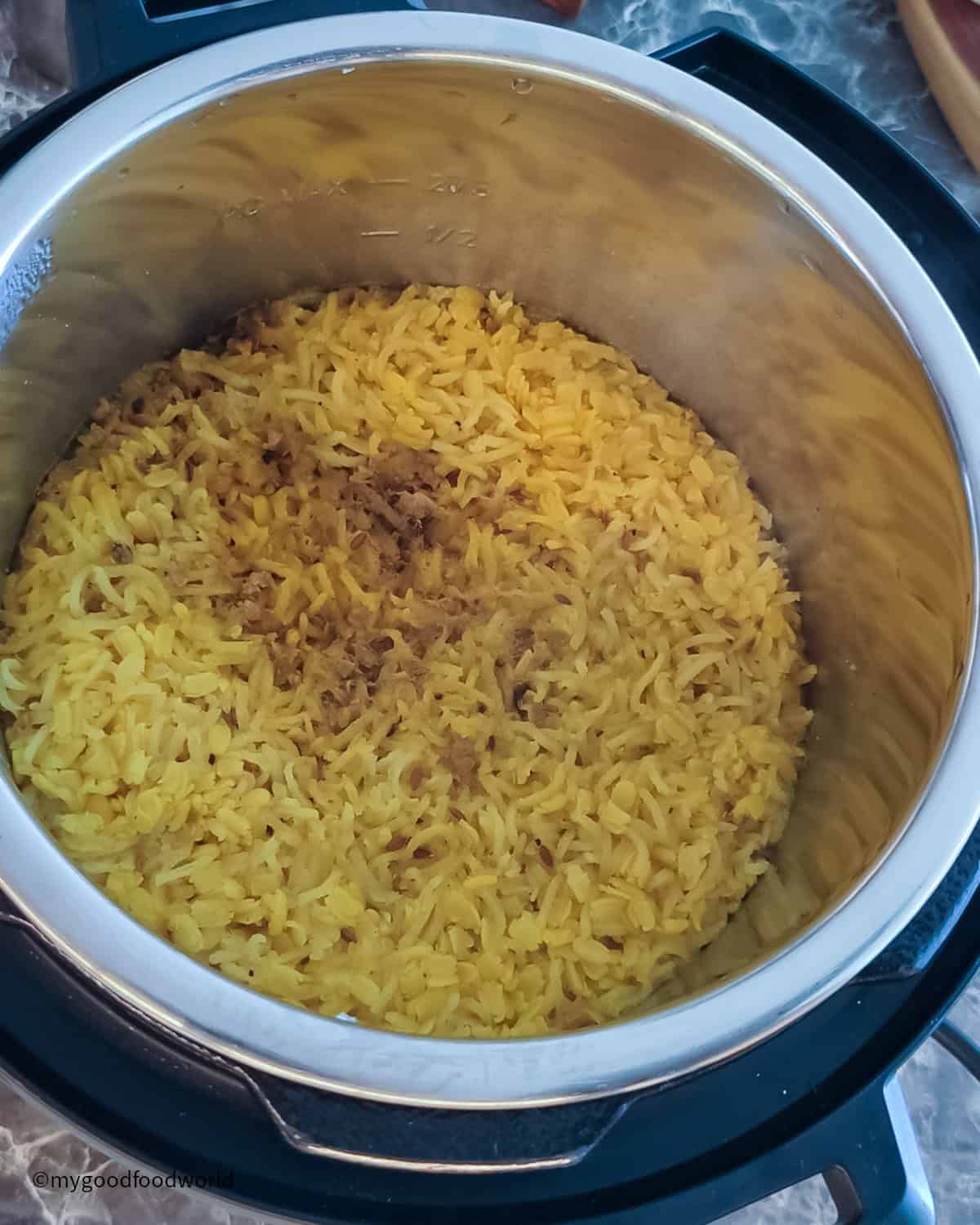 A pot filled with mung lentils and rice kitchari, cooking on the stove.