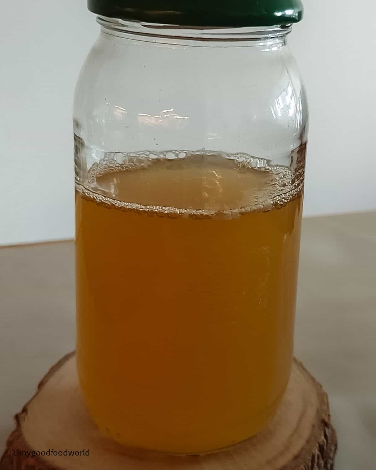 Chickpeas cooking liquid, aquafaba, is stored in a glass bottle.