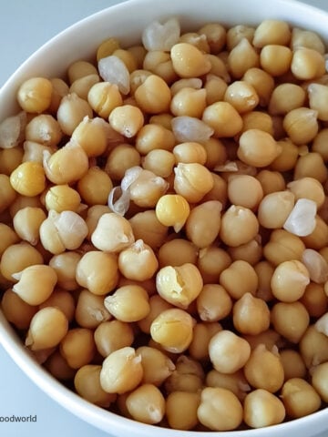 In a guide on how to cook garbanzo beans from scratch, soft and tender cooked chickpeas are placed in a bowl.