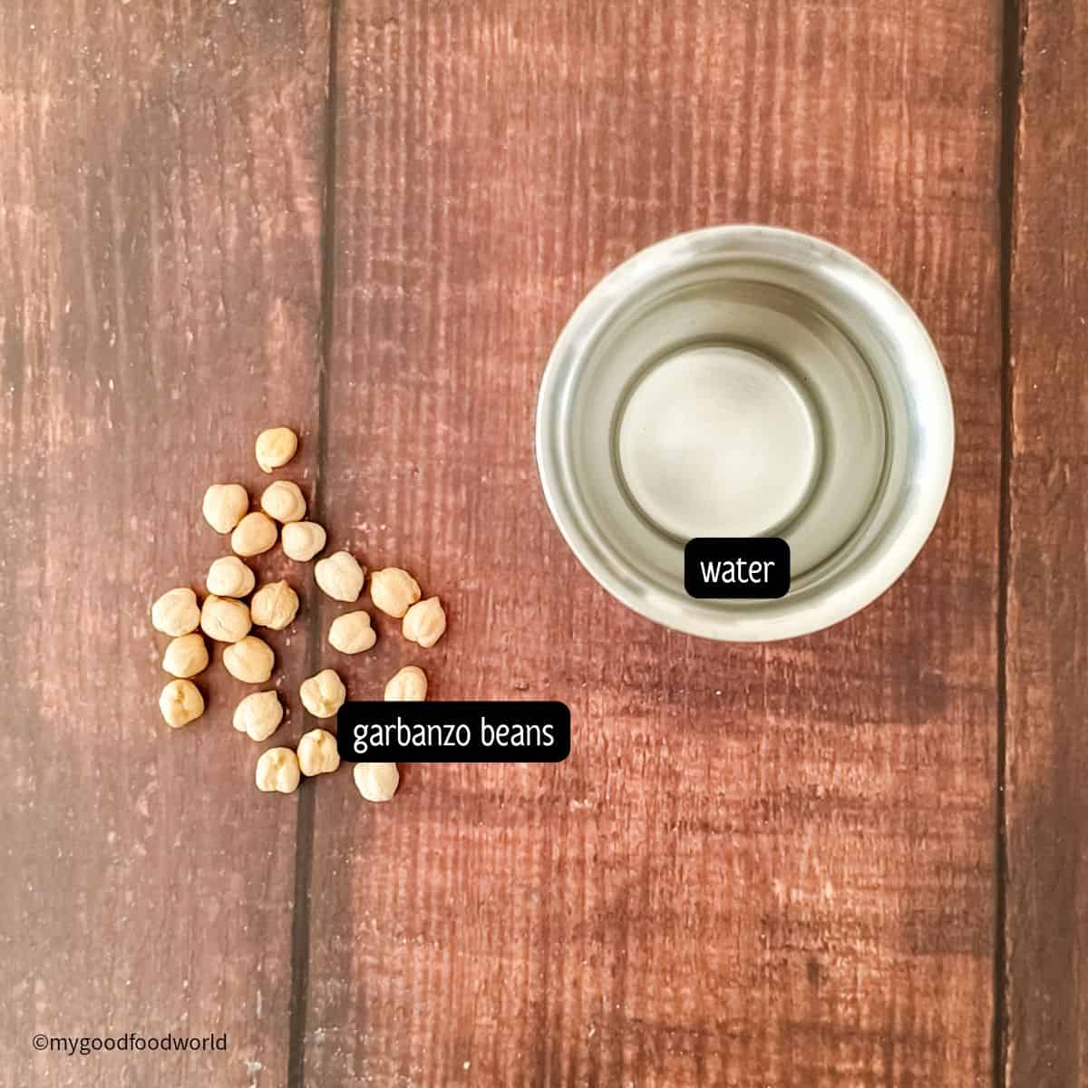Ingredients for cooking dried garbanzo beans are placed on a table top.
