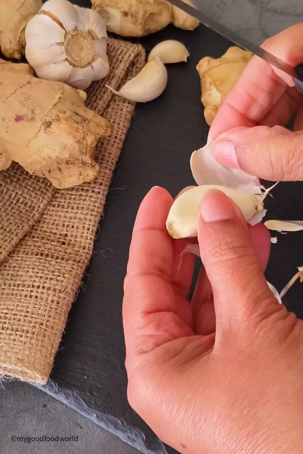 Step-by-step process of peeling garlic for homemade paste.