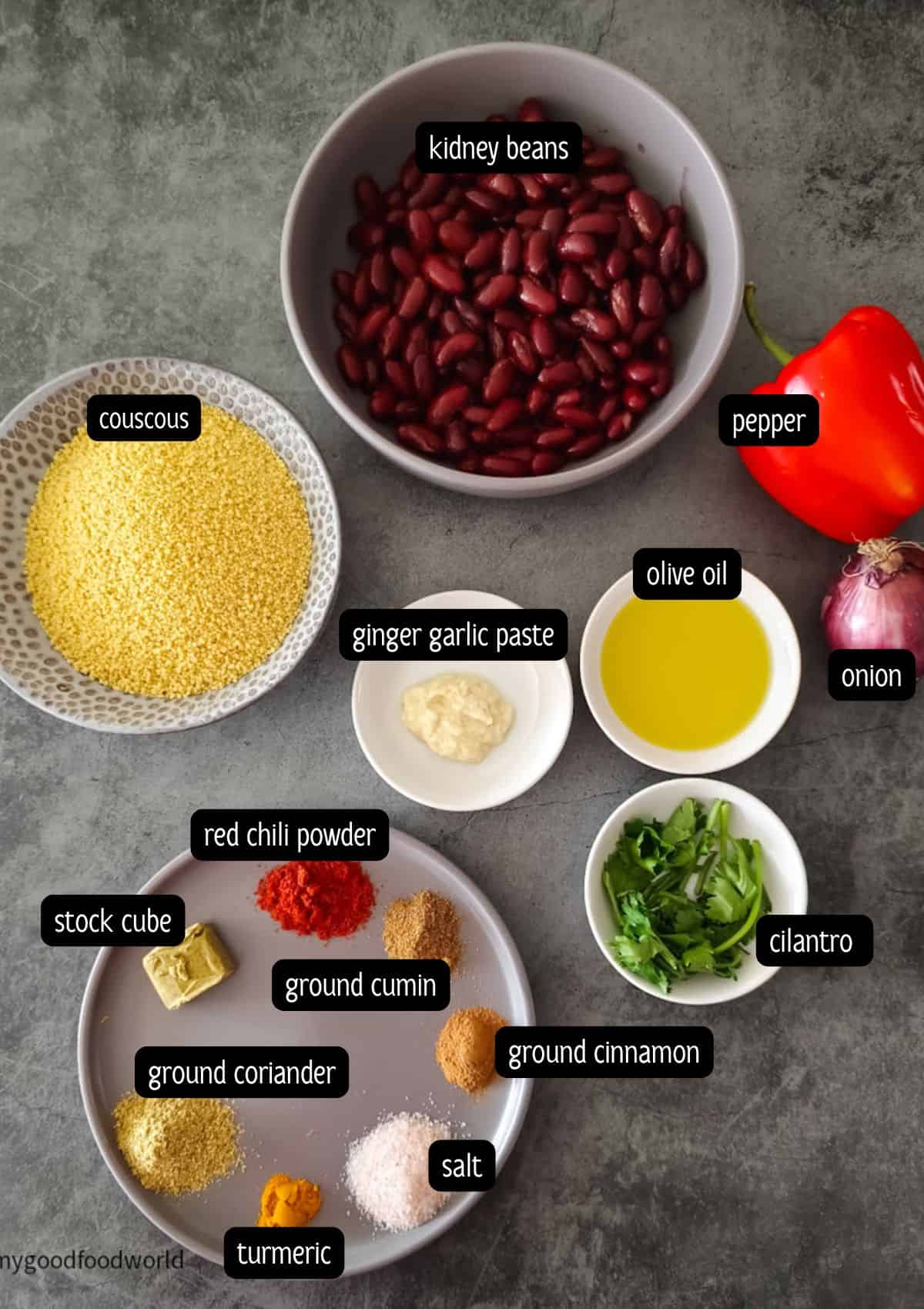 Ingredients for spicy couscous recipe: couscous, kidney beans, red bell pepper, red onion, spices, oil, and ginger-garlic paste.